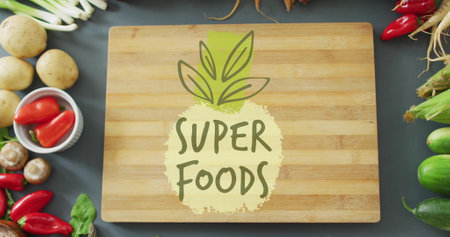 Super Foods text image over wooden cutting board surrounded by fresh vegetables. Healthy, organic, nutrition, diet, fresh produce, vitaminsの写真素材