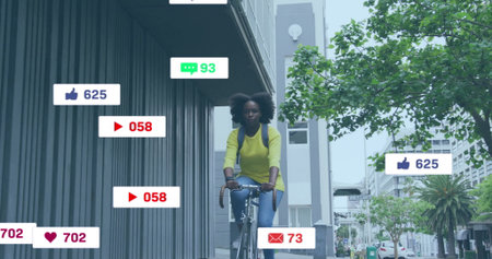 Image of social media notifications over african american woman on bike in city. Summer, healthy...
