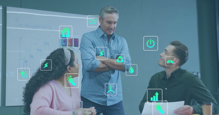Image of ecology icons over diverse colleagues discussing work in office. Global busienss, ecology, finances and digital interface concept digitally generated image.の写真素材