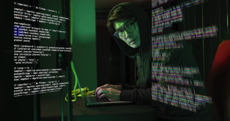 Typing on laptop, person in hoodie surrounded by digital code image