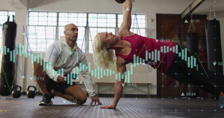 Fitness data tracking image over woman exercising with kettlebell and trainer observing