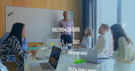 Image of numbers processing over diverse business people in officeの写真素材