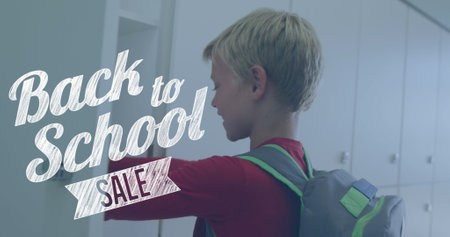 Image of back to school text over happy caucasian schoolboy at school