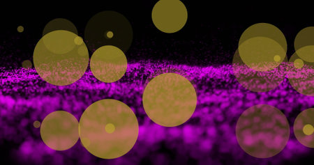 Image of yellow and purple light spots on black background