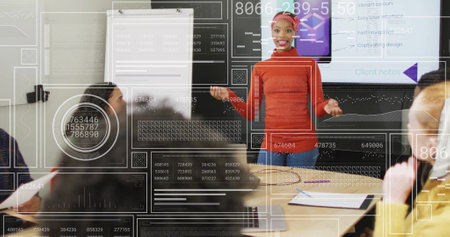 Businesswoman presenting data to colleagues, data analytics image over office meetingの写真素材