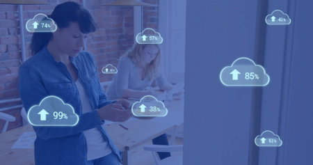 Image of cloud icons with growing number over caucasian businesswoman using smartphone. Social...