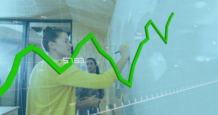 Image of multiple graphs and changing numbers, diverse coworkers writing on whiteboard in office. Digital composite, multiple exposure, report, business, growth and profit concept.の写真素材