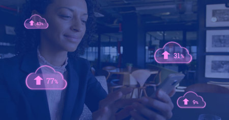 Image of cloud icons with growing number over biracial businesswoman using smartphone. Social media,...