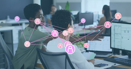 Image of network of profiles over two african american female colleagues discussing at office. Business idea and technology conceptの写真素材