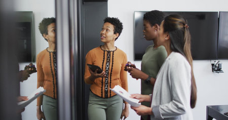 Image of data processing over diverse business people talking in office. Global business and digital interface concept digitally generated image.の写真素材