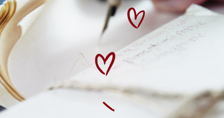Image of hearts over hand writing in notebook. Love and celebration concept digitally generated image.の写真素材