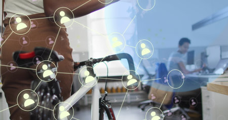 Image of globe and social media icons over diverse business people with bicycle in office. Global...