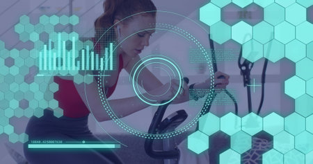 Image of data processing over caucasian woman exercising, using stationary bike. Global fitness, digital interface and connections concept digitally generated image.の写真素材
