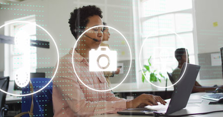 Image of data processing and icons over diverse business people using phone headset in office. Global business and digital interface concept digitally generated image.の写真素材