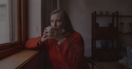 Image of moving background over sad senior caucasian woman with coffee. mental health awareness week...