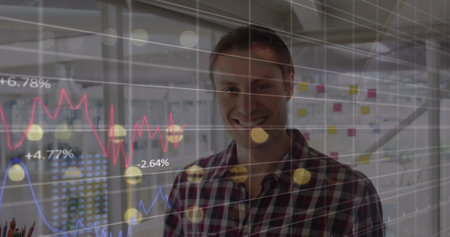 Statistical data processing over portrait of caucasian man smiling at office. Business data and...