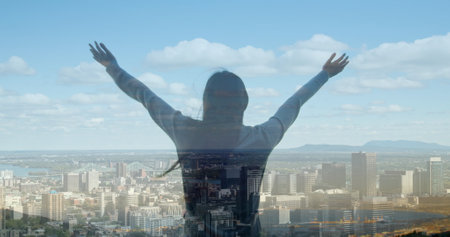 Image of cityscape over caucasian woman with arms outstretched. never give up day and celebration concept digitally generated image.の写真素材