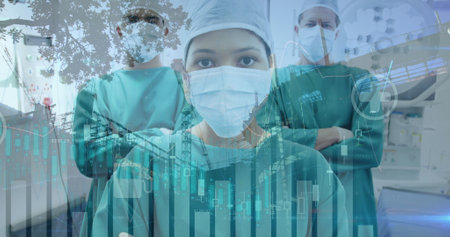 Diverse medical team wearing scrubs and masks stands ready. They have focused expressions, and digital graphics overlay sceneの写真素材