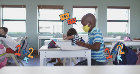 Image of falling letters and icons over diverse pupils in classroom. children day concept digitally generated image.の写真素材