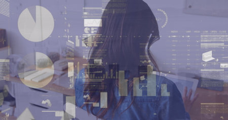 Image of statistical data processing against rear view of a woman using digital tablet at office. Business data technology conceptの写真素材