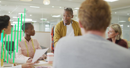 Image of multicolored graphs over diverse coworkers sharing ideas in office. Digital composite, multiple exposure, report, business, discussion, planning and teamwork concept.の写真素材