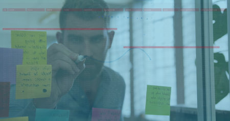 Image of data processing over caucasian businessman taking notes. global business, finances, connections and digital interface concept digitally generated image.の写真素材