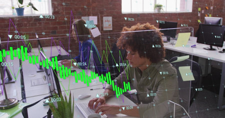 Image of multiple graphs with changing numbers over biracial man working on computer in office....