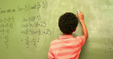 Image of math formulas over back view of biracial boy writing on black board. learning, education...