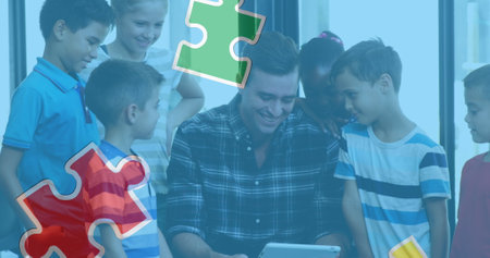 Image of colourful puzzle pieces over kids and man using electronic devices. autism, learning difficulties, support and awareness concept digitally generated image.の写真素材