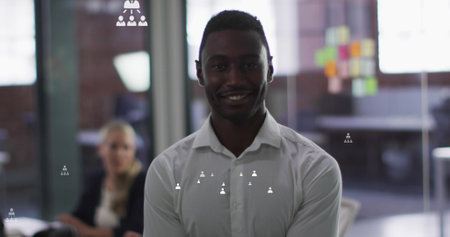 Image of connection icons over african american businessman in office. global business, digital interface and technology concept digitally generated image.の写真素材