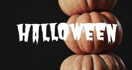 Image of white halloween text over pumpkins on black background. Halloween, tradition and celebration concept digitally generated image.の写真素材