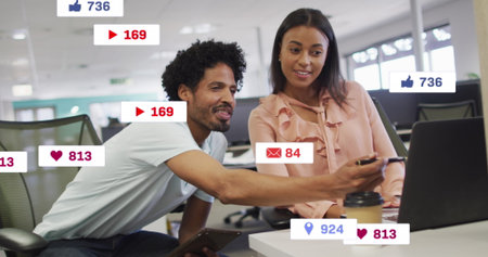 Image of notification bars over diverse coworkers discussing reports on laptop in office. Digital...