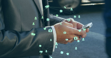 Image of globe of digital icons over mid section of businessman using smartphone on the street....