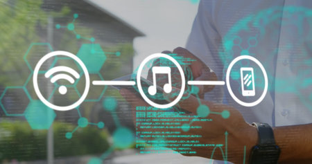 Image of scientific data and tech icons over hands of caucasian man using smartphone. Data processing and technology concept digitally generated image.の写真素材