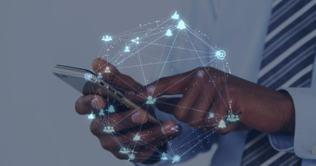 Image of data processing over african american businessman using smartphone. Global business and...