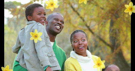 Image of failing flowers over african american family outside. family time concept digitally generated image.の写真素材