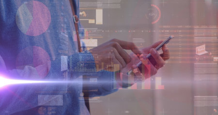 Image of graphs over hands of caucasian man using smartphone. economy, finance, communication and...