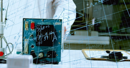 Person in lab coat stands behind glass board with equations in school. Wearing protective gloves, holding a marker, and writing mathematical formulasの写真素材
