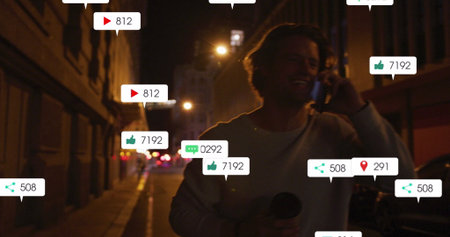 Image of social media icons and numbers over caucasian man using smartphone. Social media and global...