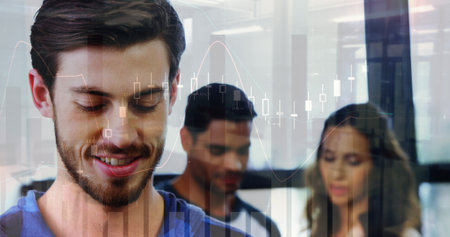 Image of financial graphs over caucasian businessman in office. business, finance, connections, technology and digital interface digitally generated image.の写真素材