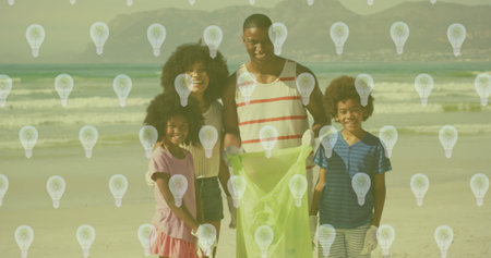 Image of lightbulb icons over african american family segregating waste. Recycle week, ecology and celebration concept digitally generated image.の写真素材