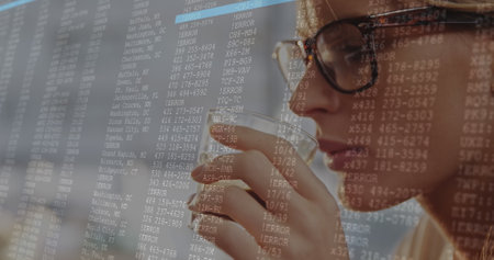 Image of data processing against close up of a caucasian woman drinking coffee. Computer interface...