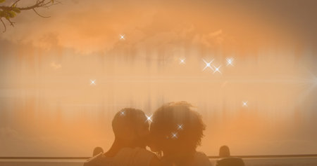 Image of shining star icons over african american couple kissing each other at the beach. Love and relationship conceptの写真素材