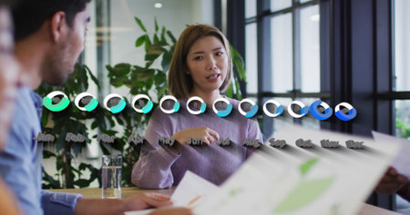 Image of data processing over diverse business people at meeting. Global business and digital...