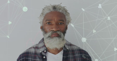 Image of data processing over senior african american man smiling. Global business and digital interface concept digitally generated image.の写真素材