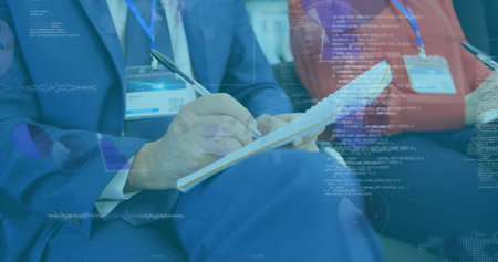 Image of diverse data on digital screen over caucasian businessman making notes. Business, cooperation, communication and technology concept digitally generated image.の写真素材