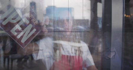 Image of landscape over man working in cafe. Global networks, business, finance, computing and data processing concept digitally generated image.の写真素材