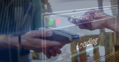 A person holding card near a payment terminal. Transparent screens showing Processing Data and Loading overlay sceneの写真素材