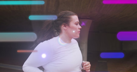 Image of data processing over plus size caucasian woman running in city street. Sports, active lifestyle, urban living and happiness concept digitally generated image.の写真素材