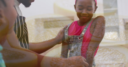 Image of african american family eating meal together in the kitchen. family quality time, cooking and food image.の写真素材